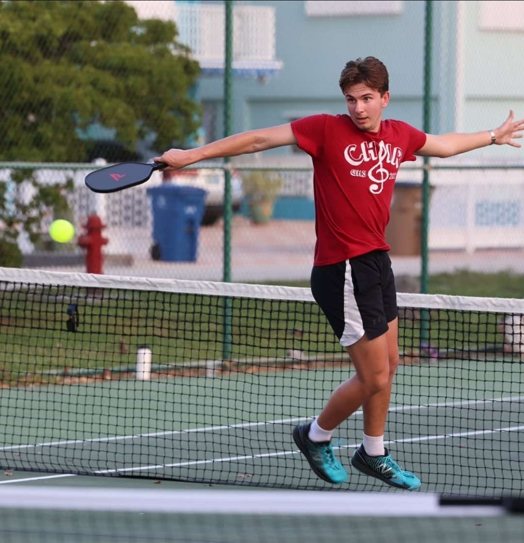 Action photo playing pickleball